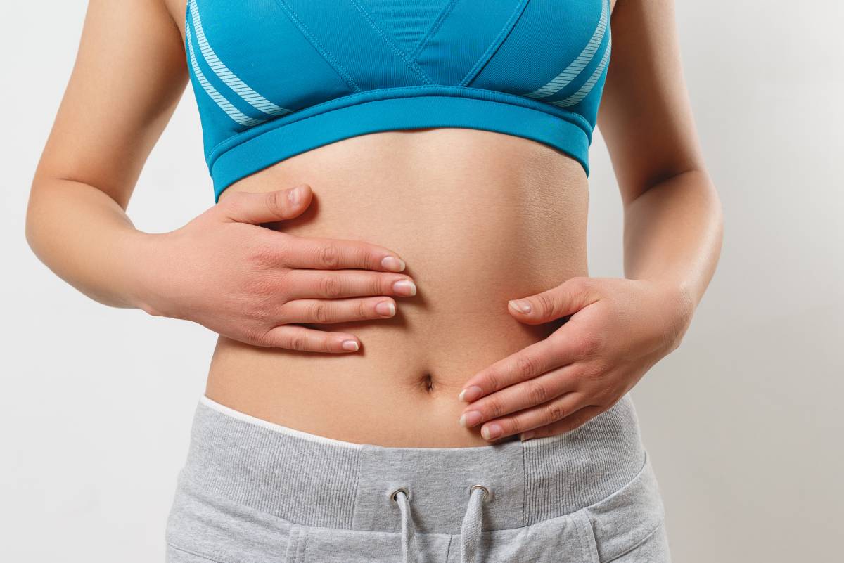 Woman touching her abdomen.